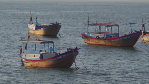Vietnamese boats in a sea at sunrise. Nha Trang, Vietnam travel landscape and destinations.