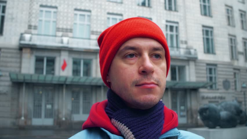 Steadicam close-up shot of male tourist walking along Vienna street. 4K video