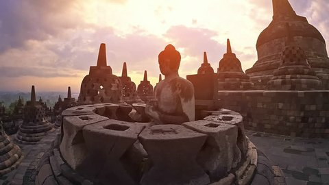 Borobudur temple java Indonesia. Mahayana Buddhist world's largest temple in Magelang. Central dome surrounded by Buddha statues, each seated inside perforated stupa. Buddhism architecture