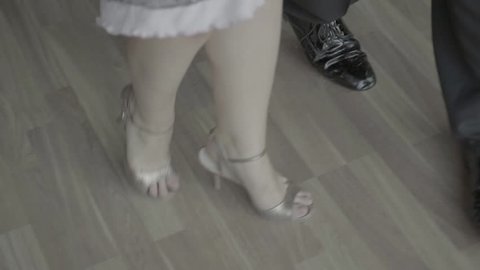 Women's and men's feet during the dance (close-up) . Slow motion