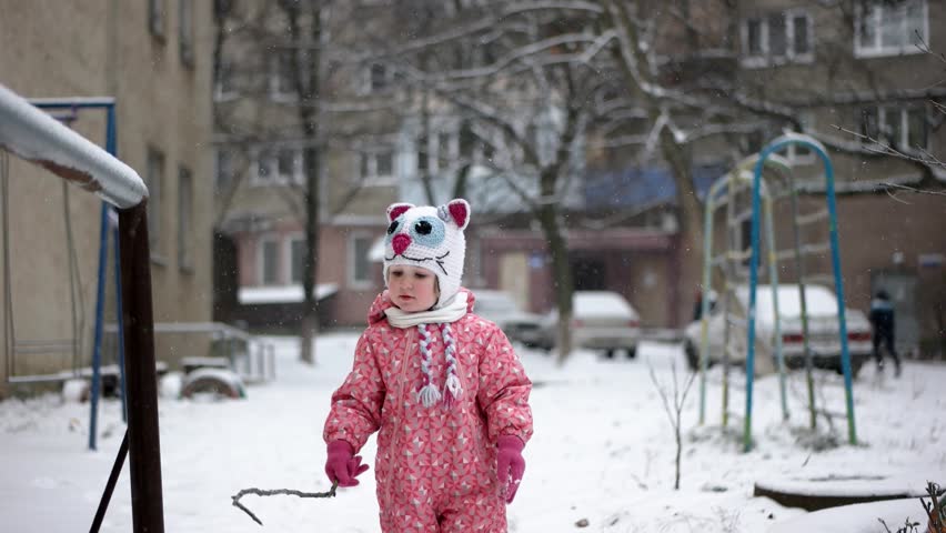 Close-Up Portrait of 3 Year Old Funny Girl Having Fun and Playing Outdoor in Winter