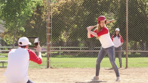 Softball player runs while friend records with tablet
