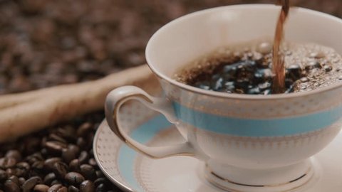 Coffee pouring into cup in slow motion