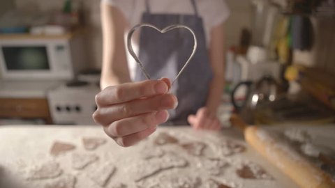 girl cooks biscuits for Valentines Day