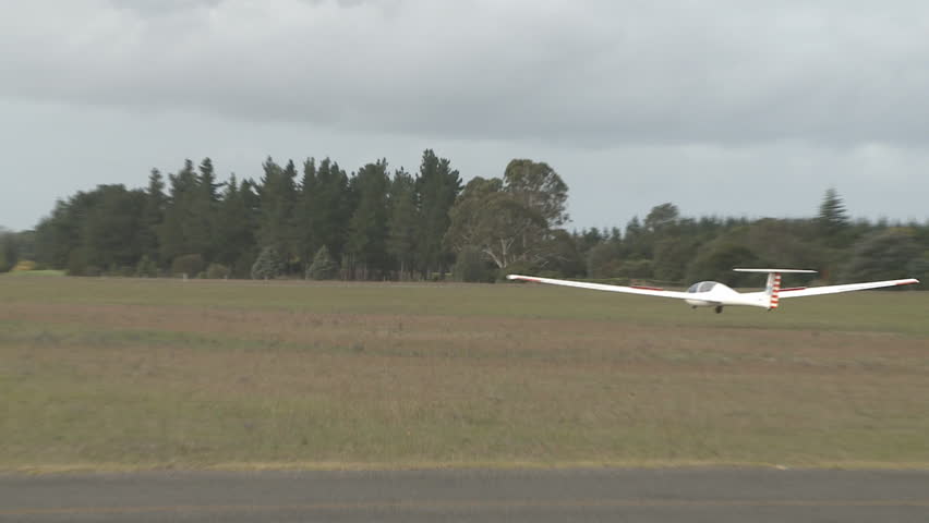 A glider lands on a grass runway 2
