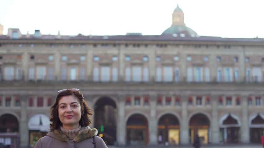 Beautiful mature woman smiling and looking at camera in the italian city of Bologna, Italy.