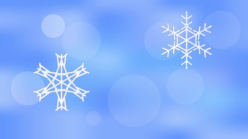 Snowflakes falling on blurry bokeh blue background.