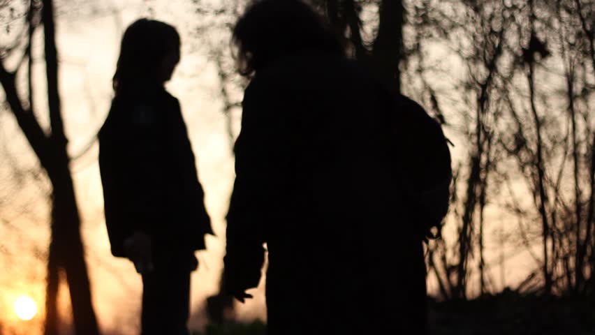 Two peaople walking in a forest