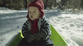 Baby being pulled on a sled from the view of the front of the sled 4k stock video clip