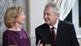 Smiling elderly woman whispering to husband - Powered by Shutterstock - Get 15% off with code: PIKWIZARD15