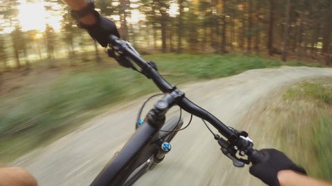 MTB bike riding on enduro mountain track trail in autumn forest. Mountain biking downhill in woods. View from first person perspective POV. Gimbal stabilized video. 