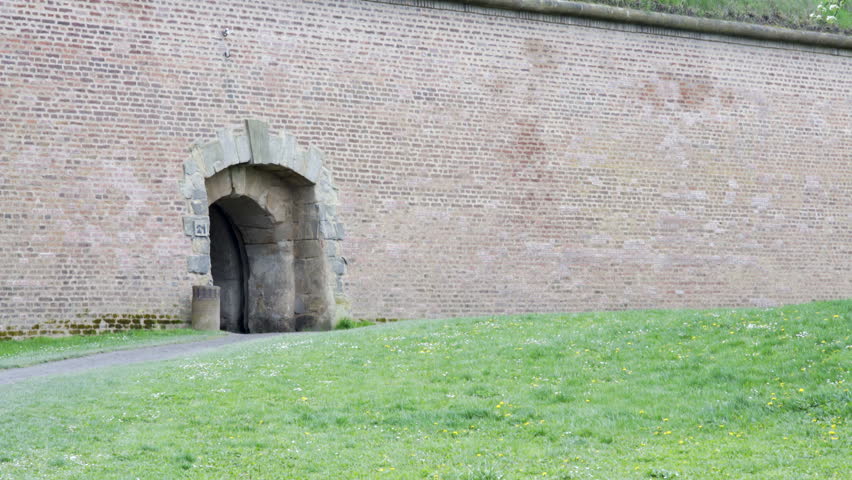 Entrance gate in red brick fortification wall, Theresienstadt camp, fortress