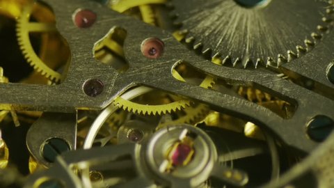 Clockwork Gears Macro (HD). Brass gears moving inside a clockwork from an open pocket-watch seen in extreme closeup. Stock-video
