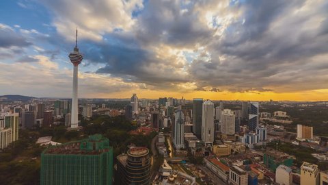 Time lapse of an afternoon in Kuala Lumpur, Malaysia overlooking the national landmark, the Kuala Lumpur Tower with dancing clouds and rays. High quality, Ultra HD, 4K resolution.
