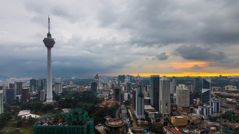 Kuala Lumpur City buildings with Malaysia National Landmarks, overhead aerial shot during a golden sunset with lightnings. Time lapse. 4K UHD. Pan Down Camera Motion.