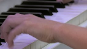 Piano hands. Young pianist playing on a white piano. Hands and keyboard close-up.
