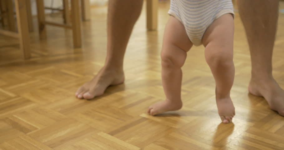 baby learning to walk on hardwood floors