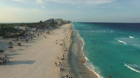 Aerial footage of Cancun beach. Drone flying above shore line with hotels