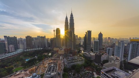 KUALA LUMPUR - FEBRUARY 12 2016: Beautiful golden sunset of Kuala Lumpur skyline overlooking the national landmarks, the Petronas Towers and KL Tower on February 12, 2016 in Kuala Lumpur, Malaysia.