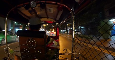 Traveling with traditional Tuk Tuk in the night. Auto rickshaws are the fastest way of getting around congested Bangkok streets. 