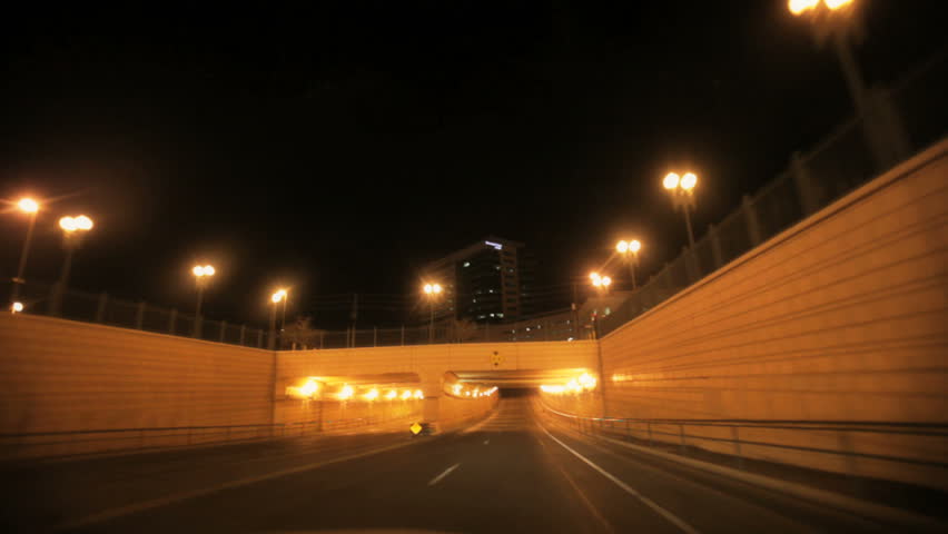 View from a car driving through a lighted tunnel