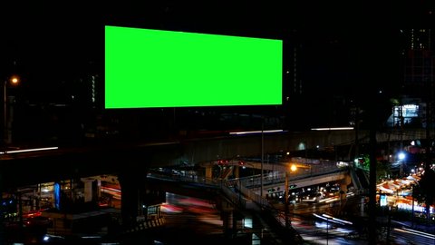 Advertising Billboard with green screen and traffic at night, for advertisement, time lapse.