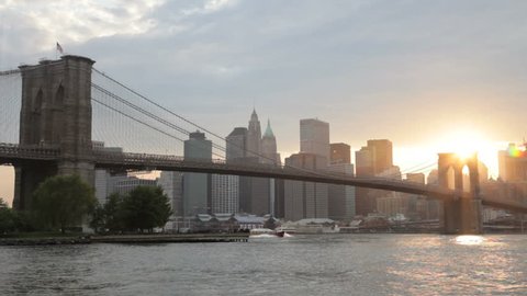 Sunset behind the Brooklyn Bridge, looking from Brooklyn over the East River toward Manhattan