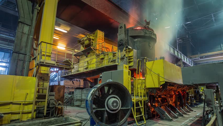 Casting of hot iron in foundry.