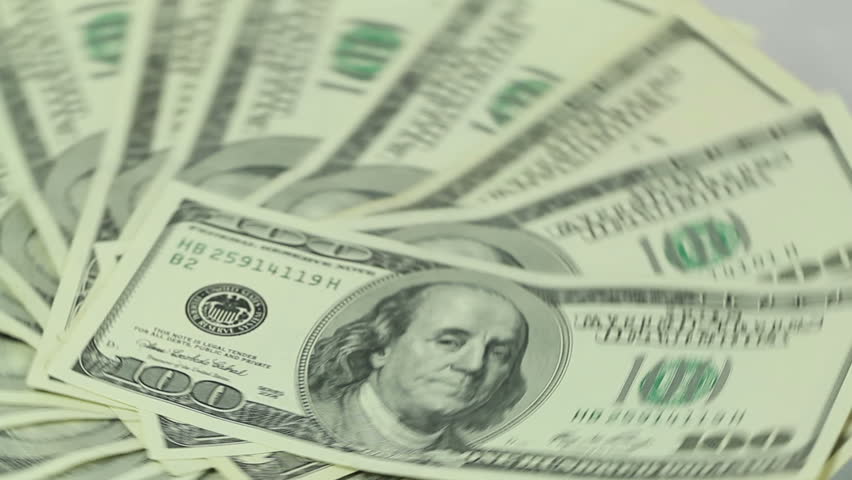Fast spinning bunch of nicely laid out one hundred dollar bills