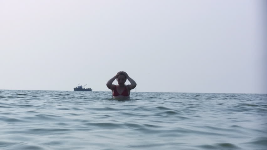 girl dives into the sea.