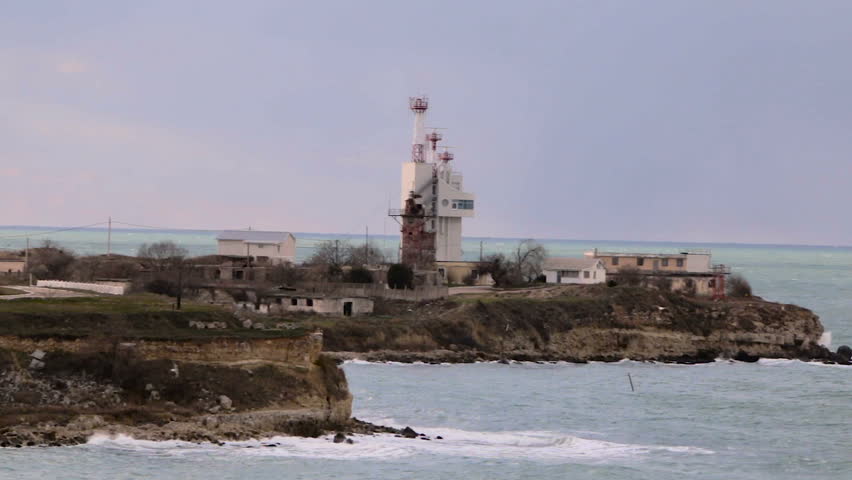 Seismic station on the rocky shore in a stormy sea. Seascape stormy sea.