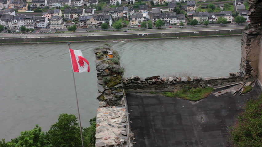 canadian flag at small castle near river rhine