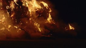 Fire storm, horrific fire destroys gigantic hay bales construction, Red Epic slow motion clip