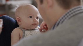 Close up slow motion shot of father holding crying baby daughter / Provo, Utah, United States