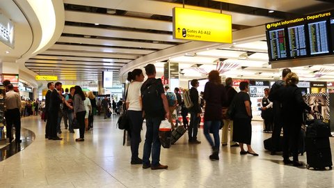 LONDON, UK - SEPTEMBER 29, 2016: A lot of people at duty free shops at Heathrow airport on September the 29th, 2016 in London, England, uk. Heathrow is one of the busiest airports in the world 
