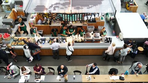 LONDON, UK - SEPTEMBER 29, 2016: People at Starbucks coffee shop at Heathrow airport on September the 29th, 2016 in London, England, UK. Heathrow is one of the busiest airports in the world 

