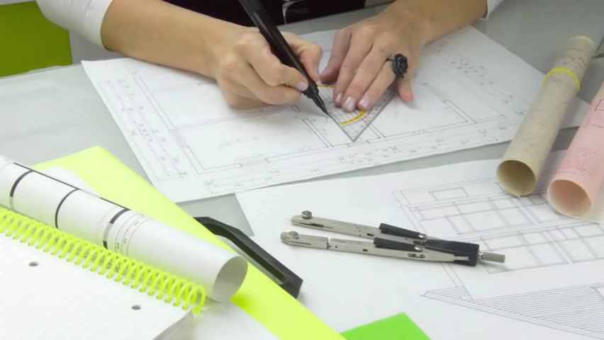 Woman architect at work. 
Architect at work drawing a plan for a new house. A model of the house in the forefront, plans on the table. Closeup. Stylish. Modern Royalty-Free Stock Footage #22780546
