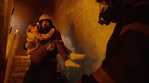 Building is On Fire. Brave Fireman Passes On Saved Girl To His Teammate. Who Brings Her To Safety. Shot on RED Cinema Camera in 4K (UHD).