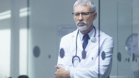 Portrait of a White Haired Senior Doctor Thinking about Patient's Diagnosis. Shot on RED Cinema Camera in 4K (UHD).