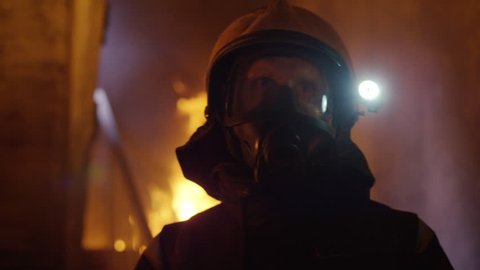 Building is on Fire. Brave Fireman Slowly Enter's the Room while Looking Around. Tongues of Flame are Licking Walls of the House. Shot on RED EPIC 4K (UHD).