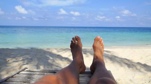 Man Feet Relaxing on Beach on Vacation