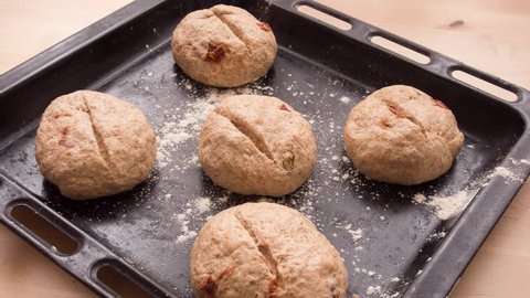 Time-lapse of rising dough of bread rolls with sundried tomato.