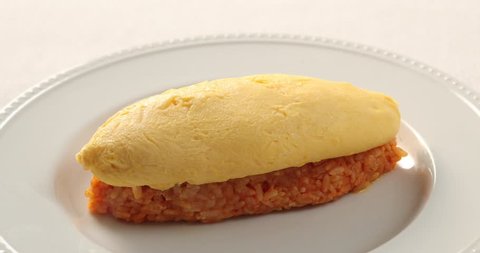 Japanese style rice omelet on white plate