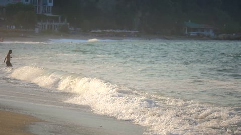 Beautiful sandy beach water splashing waves seashore people having bath summer vacation touristic destination slow motion