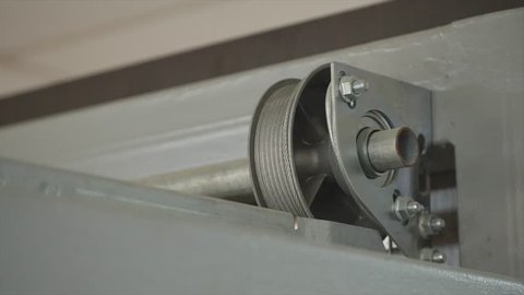 Close up on mechanical garage door opener mechanism.
