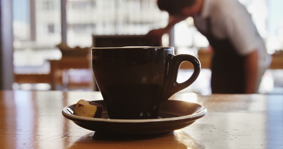 Cup of coffee on table in café 4k