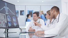 4K Medical research team in a meeting, looking patient scans via video link Dec 2016-UK