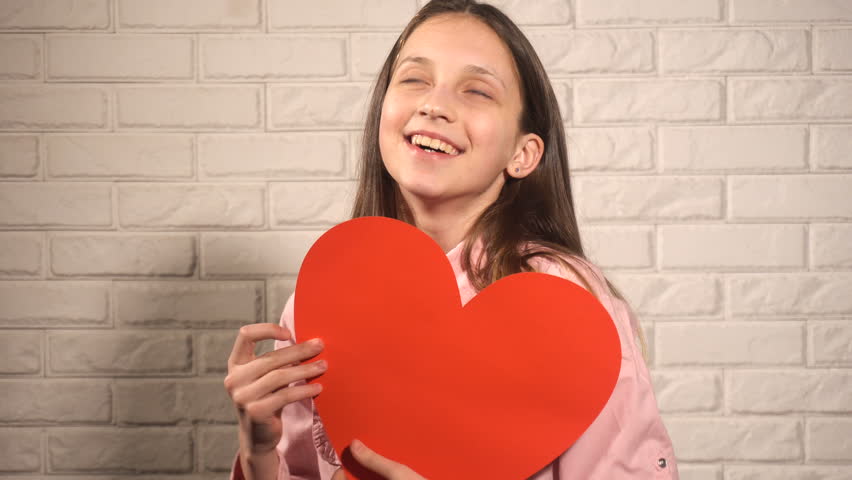 Teen girl take big read heart and happy with it