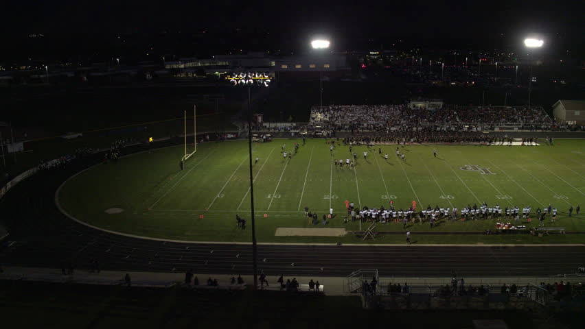 Aerial pan of High School football night game, circa September 2016.