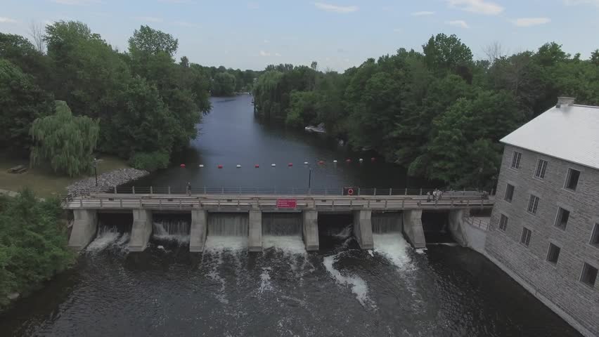 aerial scenic damn with stone building rising pullback view 4k